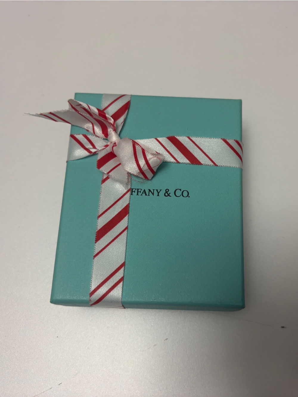 Tiffany & Co. box with candy cane ribbon and jewelry box and bag